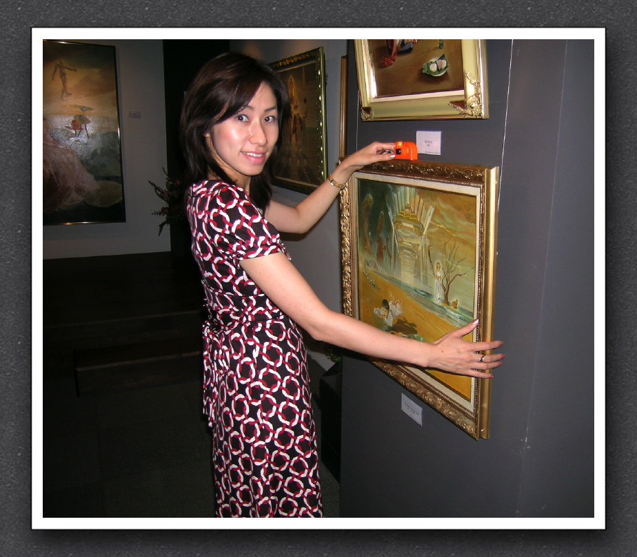 Mari checks the aligment of paintings
