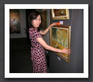 Mari checks the aligment of paintings